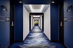 Cove lighting helps illuminate hotel corridors.