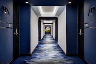 Cove lighting helps illuminate hotel corridors.