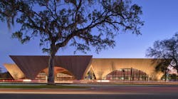 The pavilions of Winter Park Library cantilever as they rise; the forms of the library and event pavilions are accented by shielded in-grade uplights so as not to distract from the architecture. By contrast, the porte coch&egrave;re (foreground) features internal uplighting.
