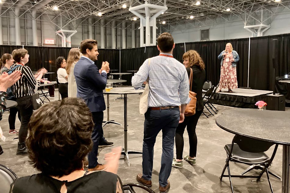 Alana Shepherd, founder of the nonprofit North American Coalition of Lighting Industry Queers, greets attendees at NACLIQ&apos;s ice cream social, an event held on the LightFair show floor.
