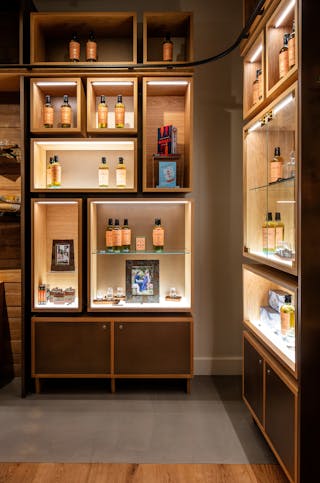 Feature lighting highlights Ad Gefrin products in the retail store.