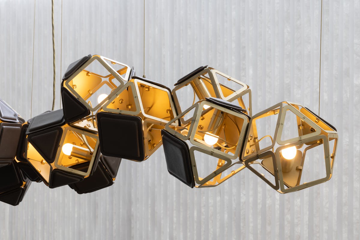 Detail view, Welles Long Chandelier 16, in satin brass and sparrow brown leather, by Sybille de Margerie for Gabriel Scott
