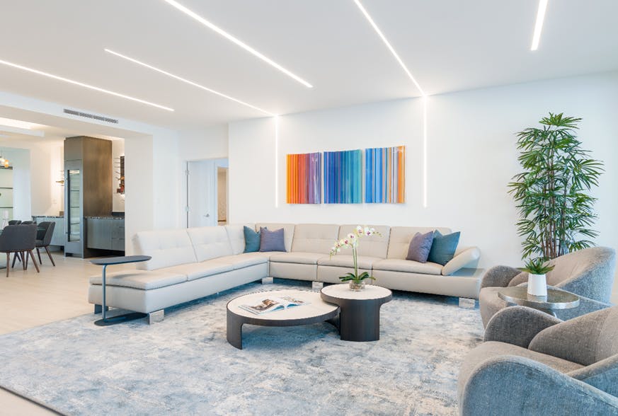 For this contemporary living room, Light Up Your Life specified PureEdge Lighting&apos;s TruLine, which aligns with the artwork and seating areas.
