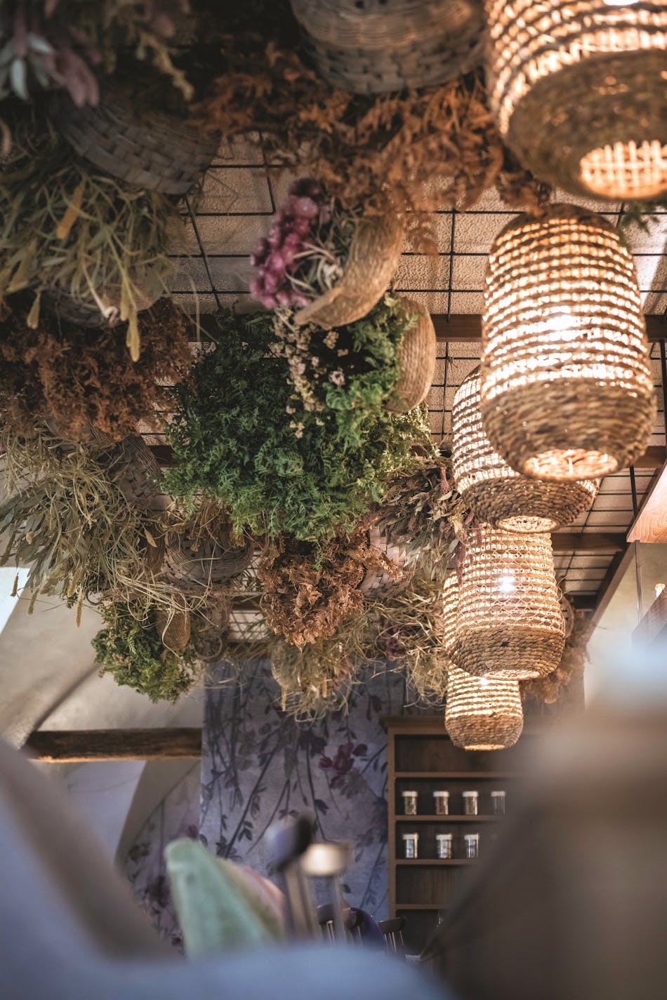 The ceiling of upturned flower baskets is further complemented with hanging rattan lamps.