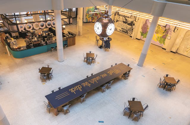 Customers can gather under the historic copper clock suspended in a place of prominence within the food court.