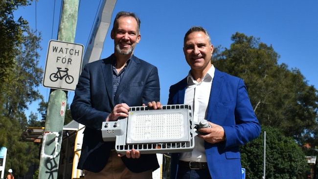 Marc England, Ausgrid's CEO, and Cr John Faker, SSROC's president, show the street lighting luminaire.
